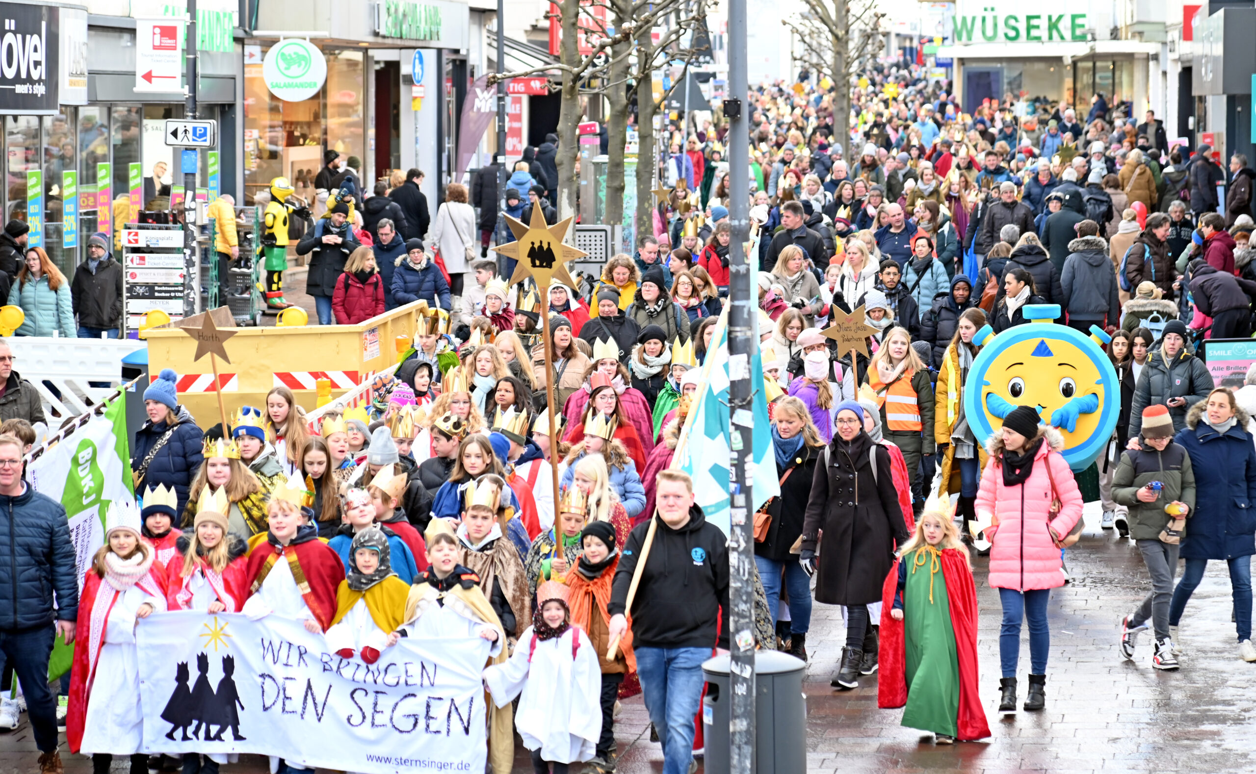 Die Sternsinger und Sternsingerinnen ziehen in ihren bunten Gewändern und mit ihren glänzenden Kronen durch die Innenstadt Paderborns. Mit dabei: Stoppi, das Maskottchen der 72-Stunden-Aktion.